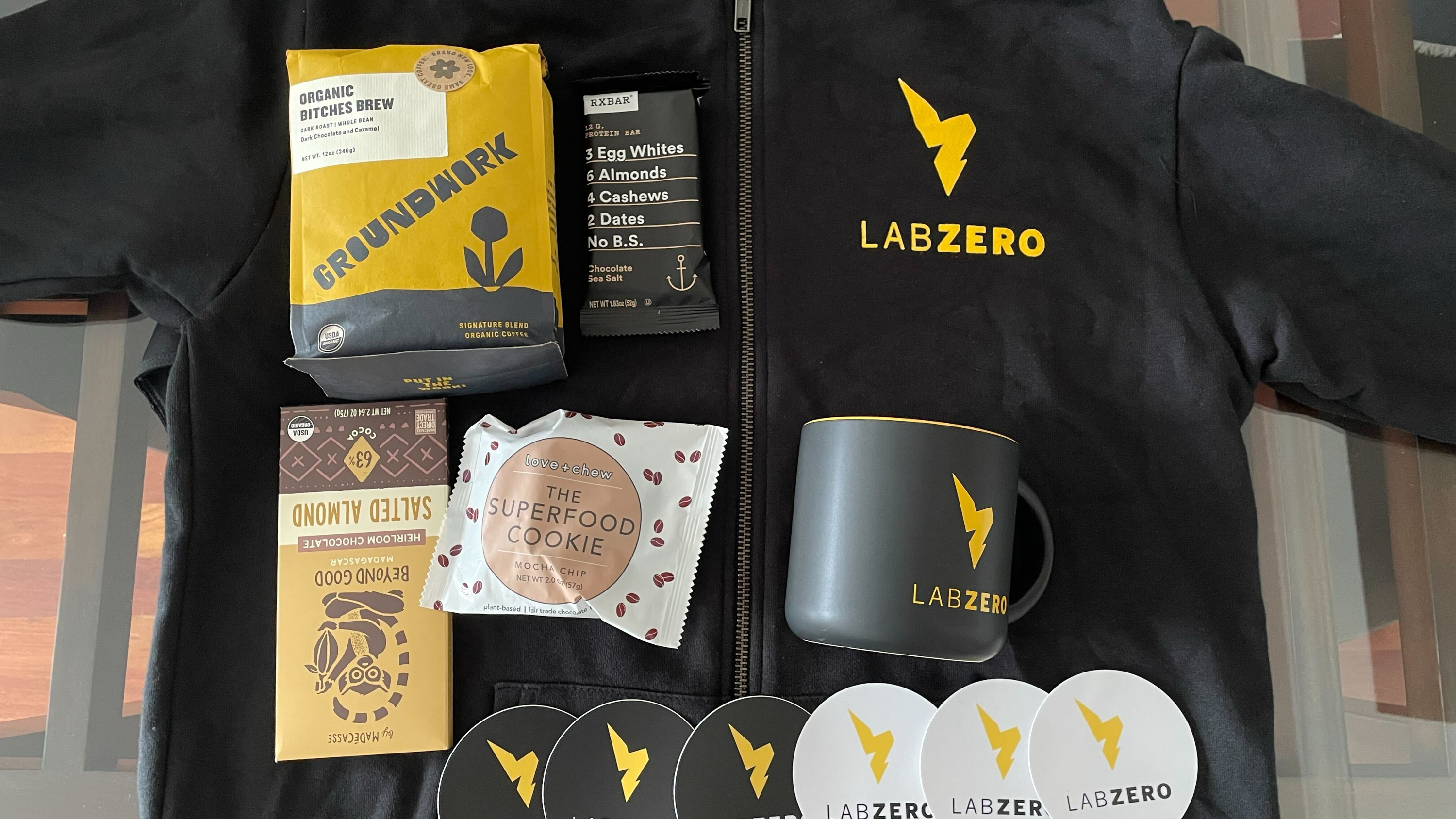 Lab Zero welcome kit includes a hoodie, stickers, a coffee mug, and snacks